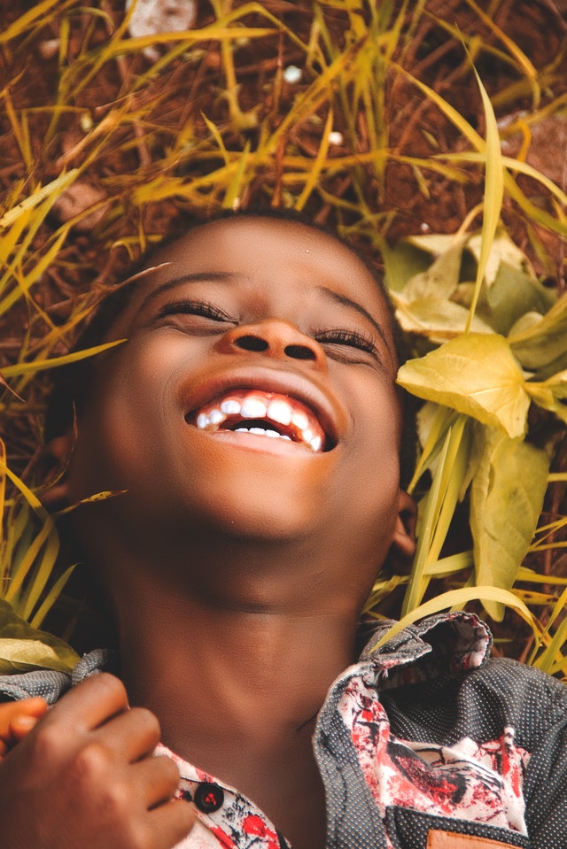 Child laughing in the brush